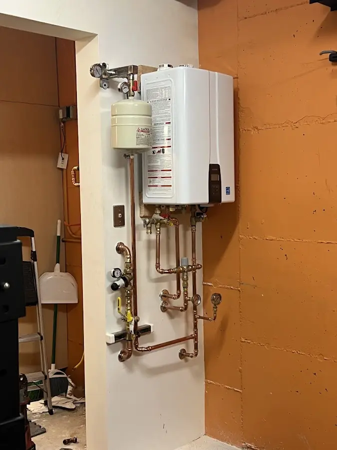 Plumbing technician inspecting water heater connections in Kearny